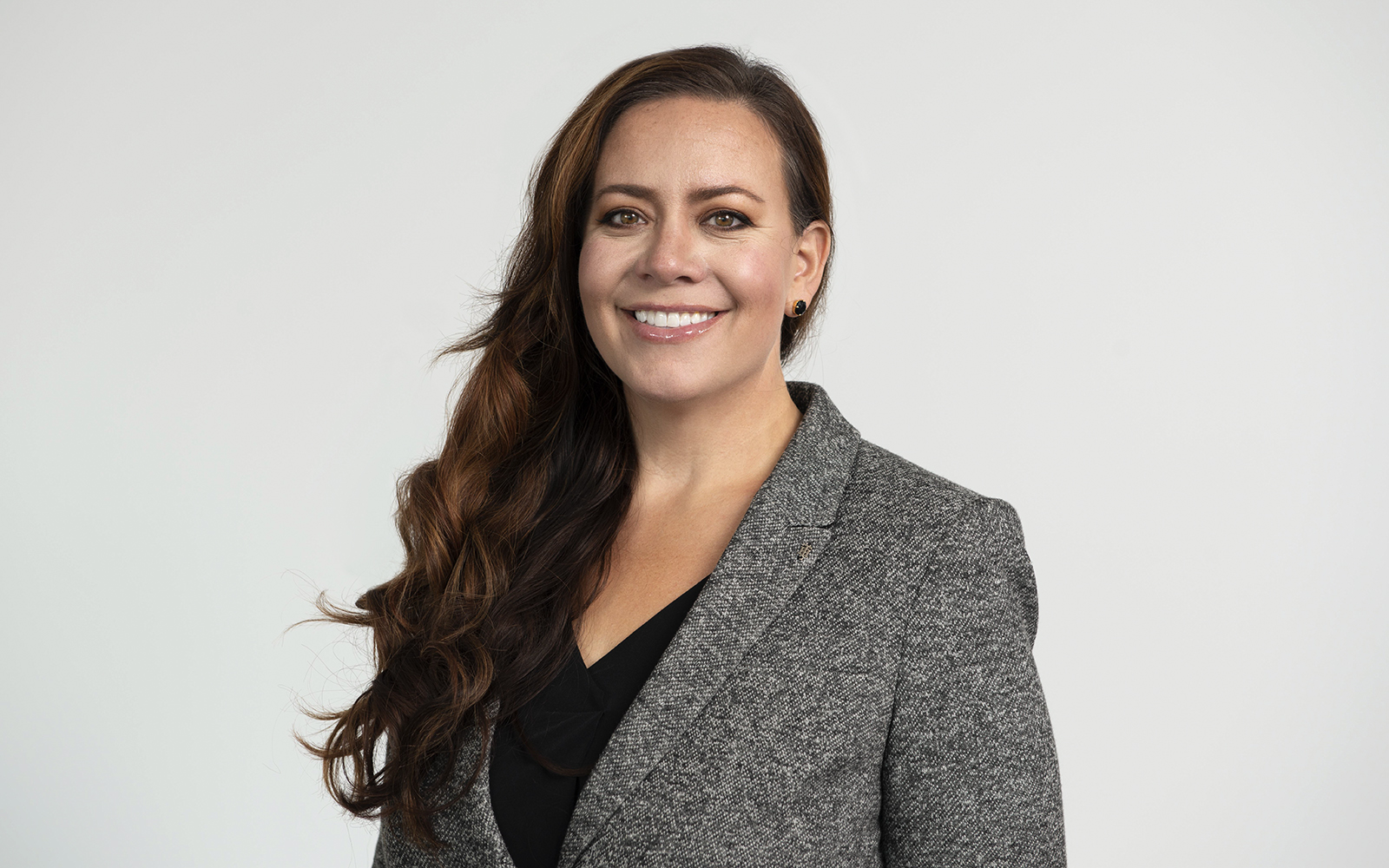 Abby Figueroa the Atria Senior Living SVP of Functional Operations smiling for the camera.