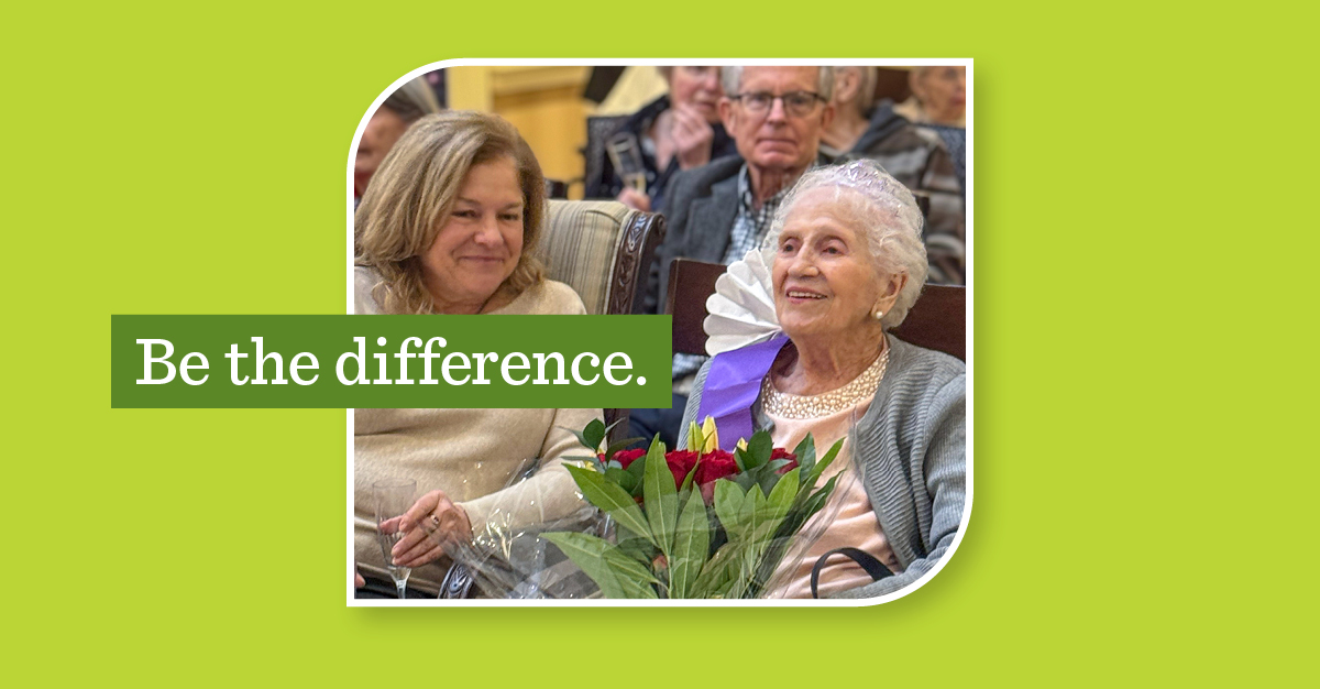 Older and younger women sitting next to each other, holding wine and flowers. A green overlay says "Be the difference."