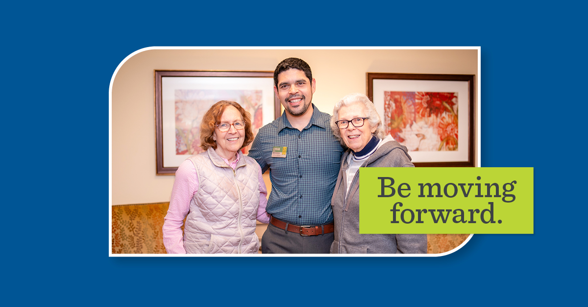 Adrian posing with two older women on either side. A green overlay says, "Be moving forward."